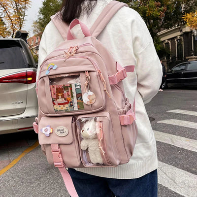 Kawaii pink backpack with multiple pockets, waterproof fabric, and a transparent pouch with plush bear – ideal for students
