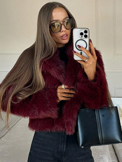 Woman wearing burgundy faux fur coat – vintage style long sleeve warm winter jacket