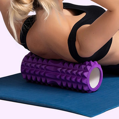 Purple yoga foam roller with textured grid for muscle massage, Pilates, and home workout recovery