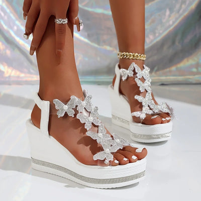 Women’s crystal butterfly wedge sandals with rhinestone details and clear PVC straps, white platform party heels