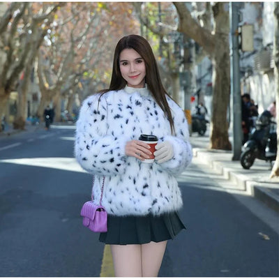 Woman wearing white leopard print faux fur jacket with round neck – Winter 2025 highstreet fashion