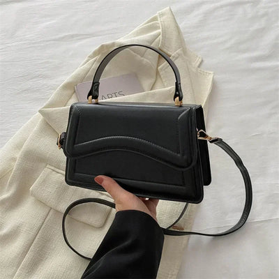 Elegant black PU leather women’s handbag with top handle and crossbody strap – small tote purse